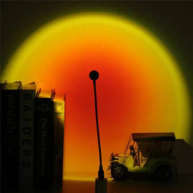 Sunset Mood Lamp Light casting a warm, colorful glow on books and decor.