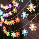 Colorful LED Snowflake Lights illuminating a festive holiday scene.