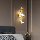 Nordic LED pendant light in elegant gold, illuminating a bedroom interior.