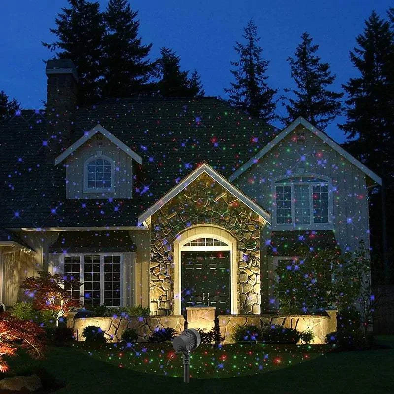 Christmas Laser Projector Lights decorating house exterior with colorful starry effects.