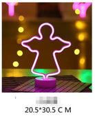 Angel-shaped LED Neon Light in pink on a table, creating a vibrant ambiance.