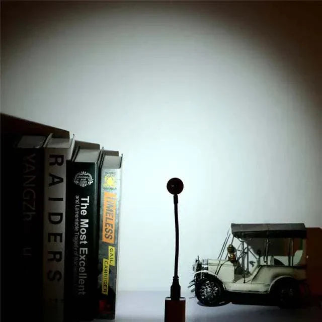 Sunset Mood Lamp Light illuminating a shelf with books and a model car.