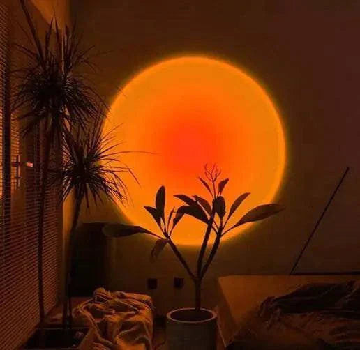 Sunset Mood Lamp Light casting warm, soothing sunset hues in a cozy room with plants.