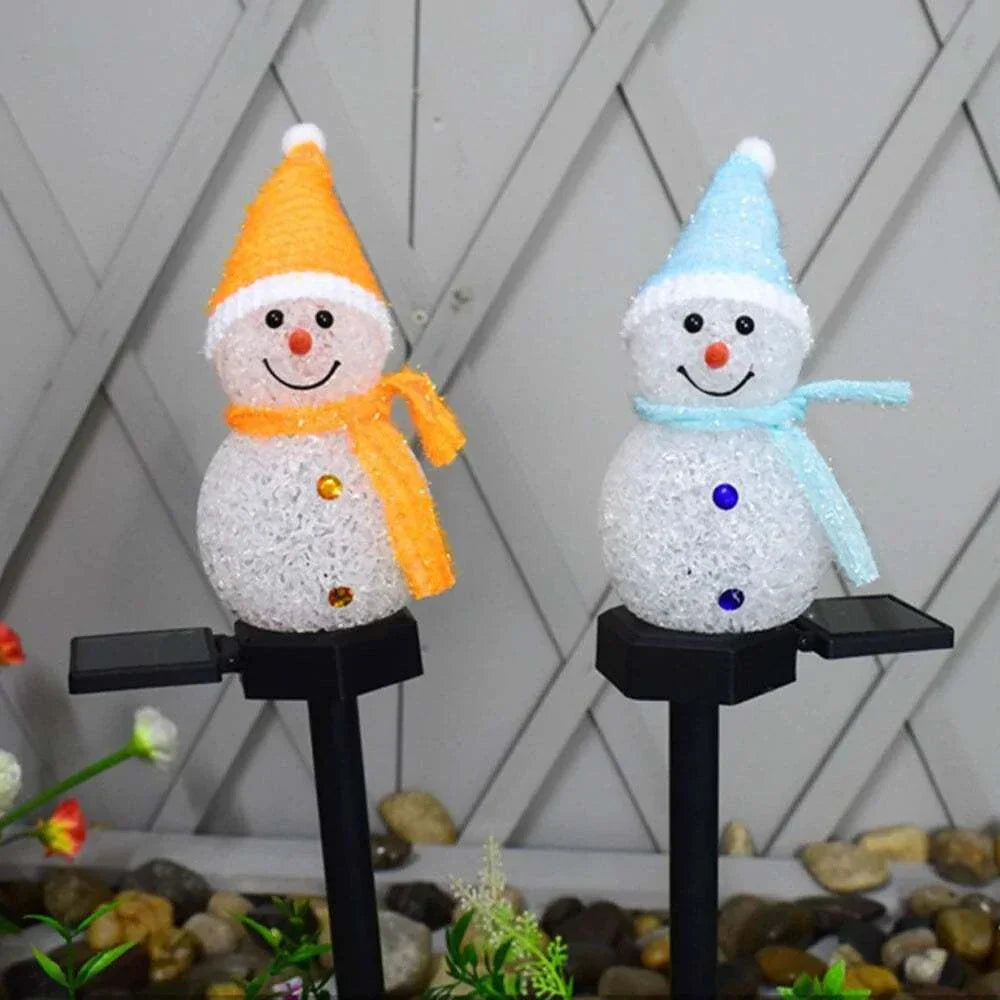 Solar Christmas lights snowman outdoor decoration on stakes with colorful scarves.