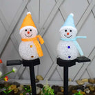 Solar Christmas lights snowman outdoor decoration on stakes with colorful scarves.