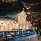 Christmas Laser Projector Lights creating festive starry effects on house and garden.