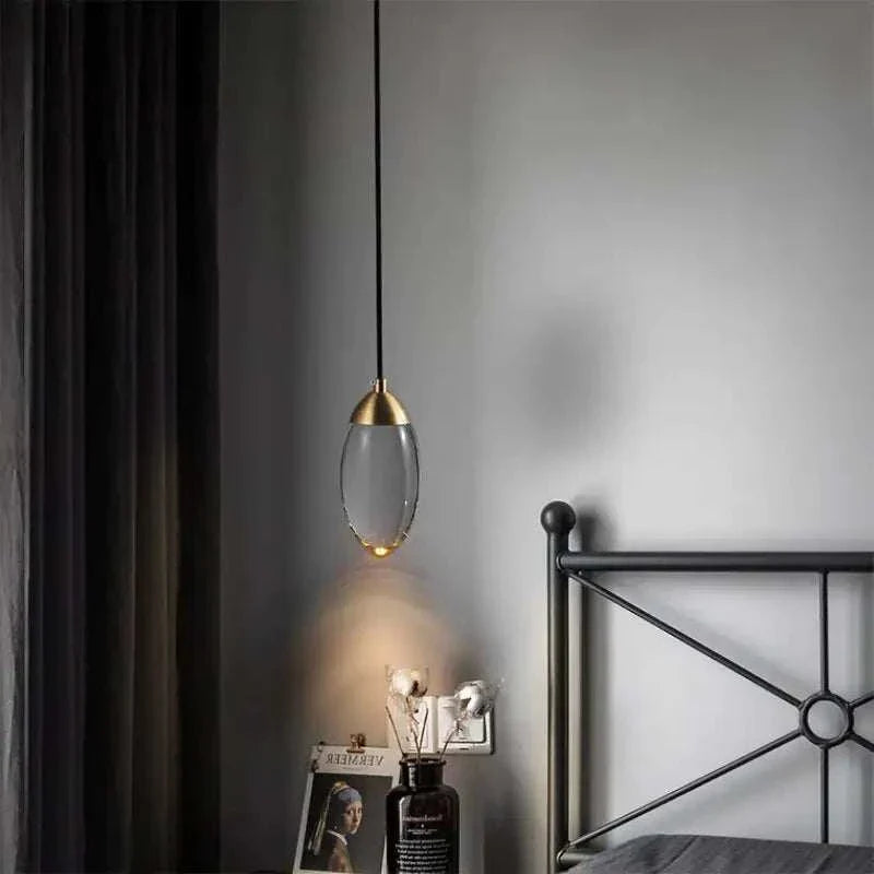 Elegant Raindrop Pendant Light illuminating a modern bedroom interior.