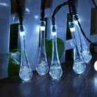 Dewdrop-inspired garden solar lights illuminating an outdoor space with a cool white glow.