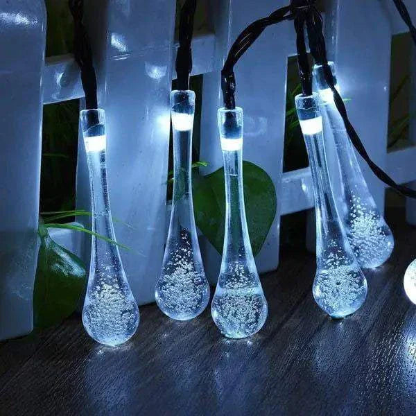 Dewdrop-inspired garden solar lights illuminating an outdoor space with a cool white glow.