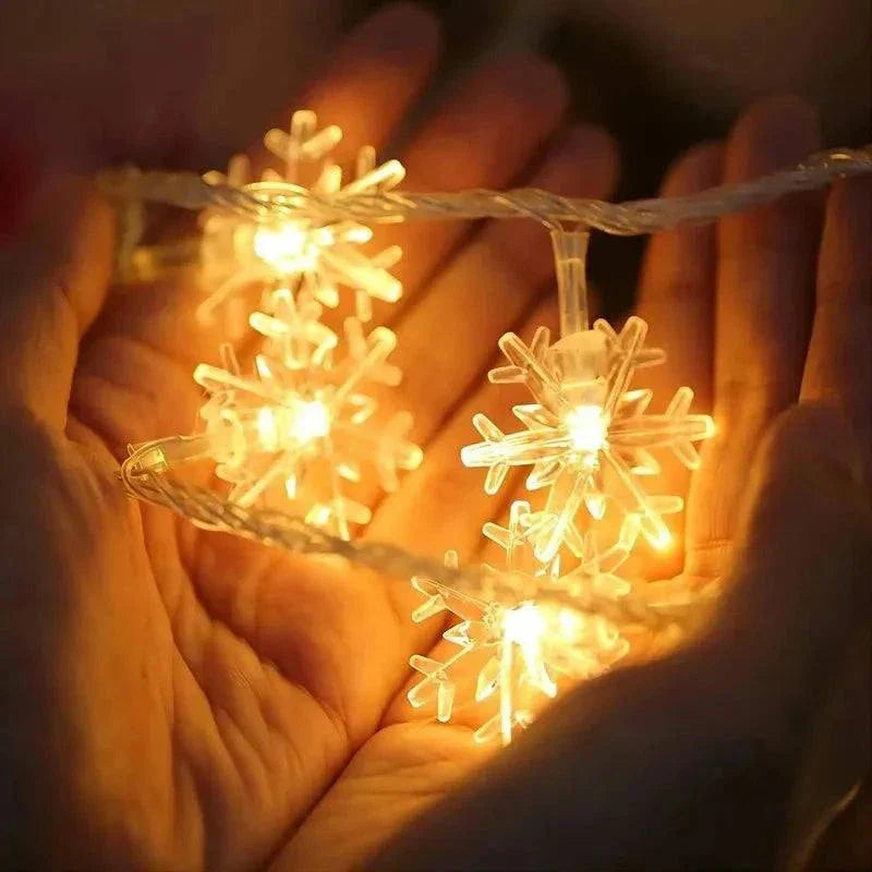 LED snowflake lights glowing warmly in hands, perfect for holiday decor.