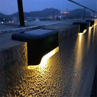 Solar lights illuminating outdoor staircase at night for safety and ambiance.