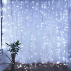 Christmas curtain lights illuminating a room with a warm festive glow.