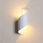 Marta LED waterproof outdoor lighting on a wall, providing warm illumination.