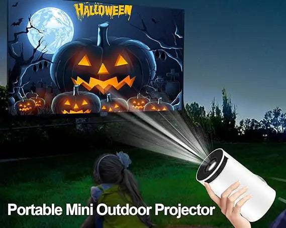 Portable mini outdoor projector displaying Halloween scene on screen.