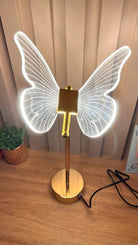 Golden Butterfly Lamp illuminating space with sophisticated design.