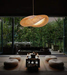 Eco-Chic Bamboo Pendant Lights hanging in cozy, modern room with outdoor garden view.