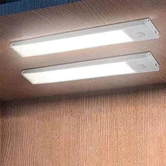 Under counter LED lights installed beneath a wooden cabinet.