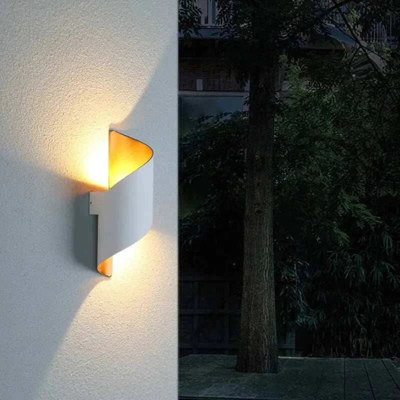 Marta LED waterproof outdoor lighting mounted on a wall, illuminating a garden space.