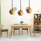 Wood pendant lights in a modern dining room setting with wooden furniture and decor.