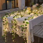 Green Leaf String Lights decorating a dining table with warm white illumination.