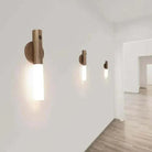 Wireless Rechargeable Wall Lamp mounted on white wall emitting soft warm light.