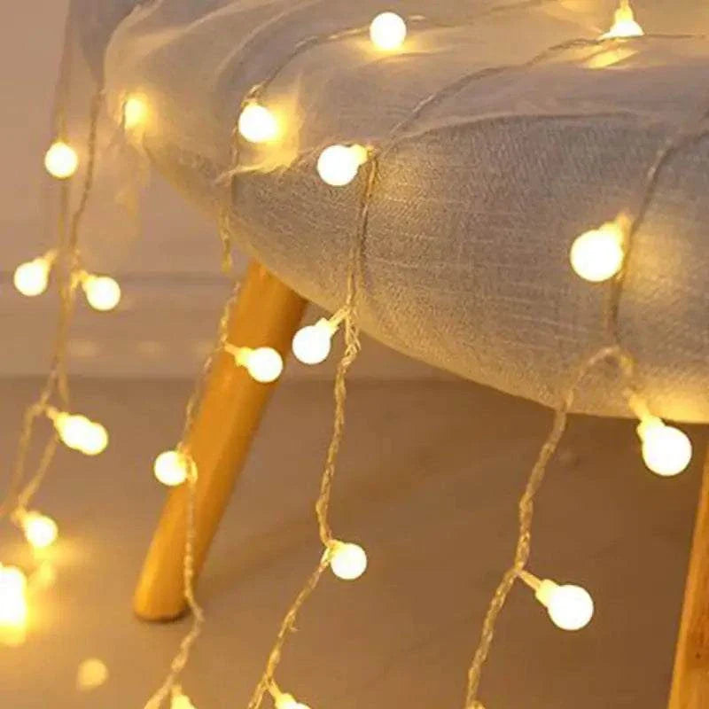 LED fairy string lights draped over chair, Sunshine Pearl Lights 16-foot strand.