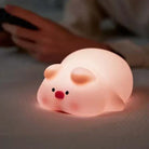 LED night light shaped like a cute sheep with a warm glow, ideal for children's rooms.